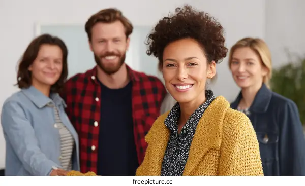Diverse Group of People Smiling and Handshaking in a Positive Business Setting