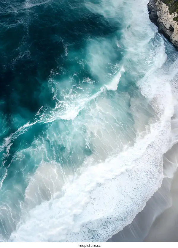 Aerial View of Ocean Waves Crashing on the Shore