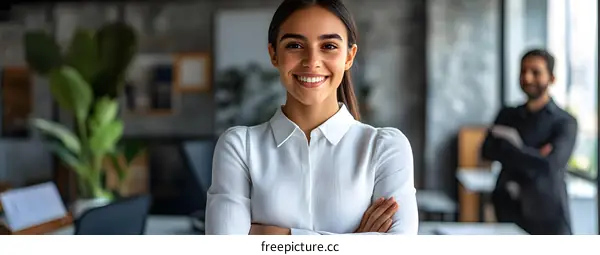 Smiling Businesswoman Standing with Arms Crossed