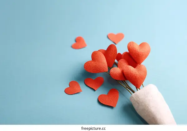 Handmade Red Paper Hearts Bouquet on Light Blue Background