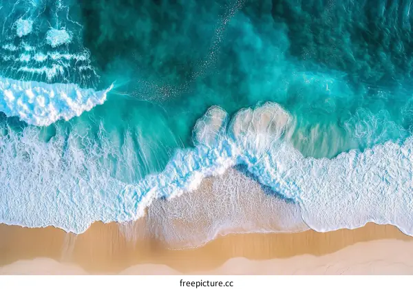 Aerial View of Turquoise Waves Crashing on Golden Sand