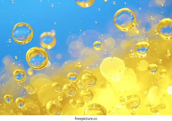 yellow oil bubbles floating on blue water surface