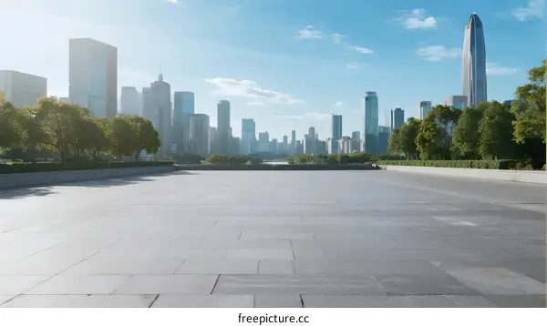 Modern city skyline with wide open plaza under clear blue sky