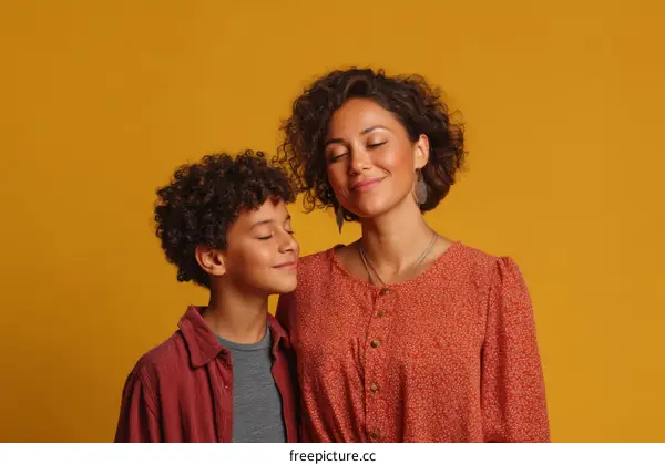 Mother and Son Portrait Against Mustard Background