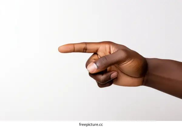 A hand with dark skin pointing to the right