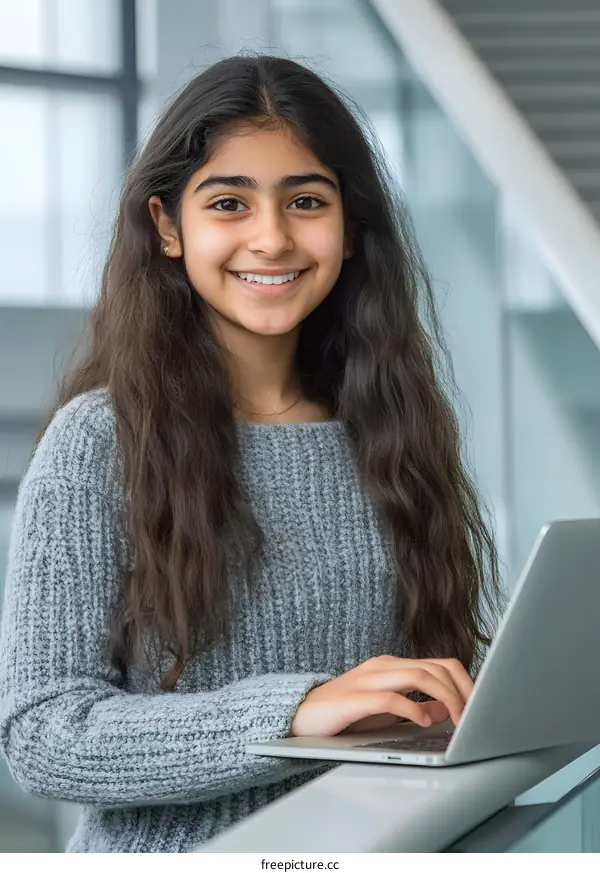 Smiling Indian Teen Girl Using Laptop