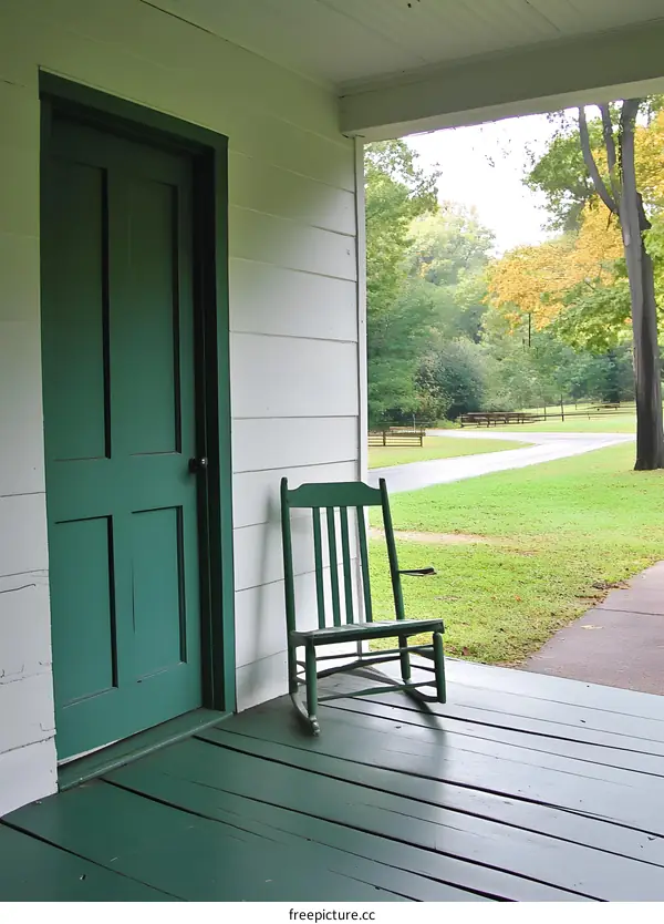 Green Rocking Chair on a Porch with a Green Door