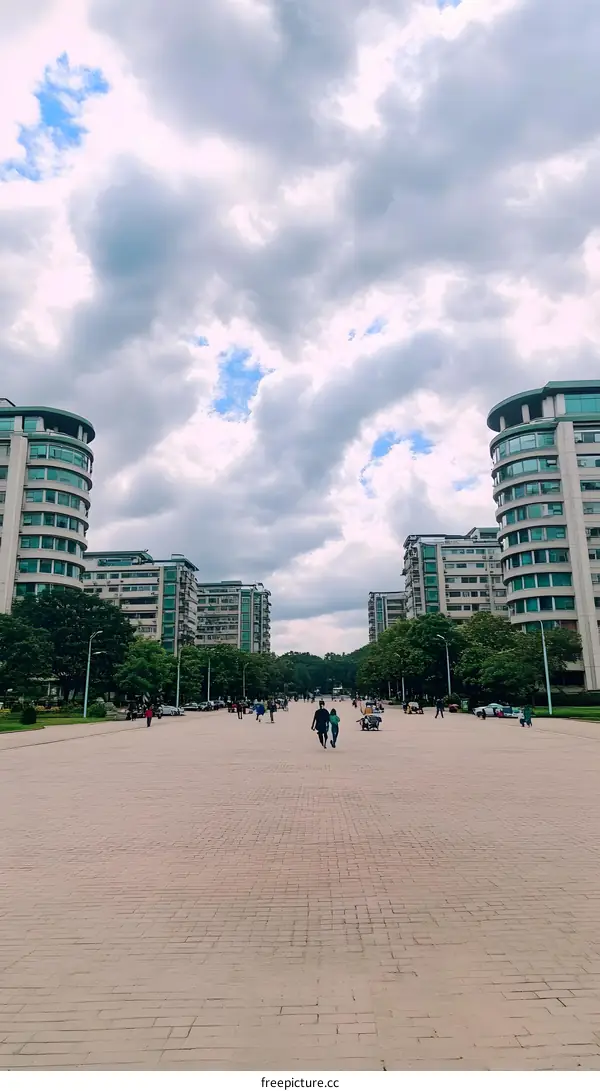 Modern Buildings and Sky with People Walking on Pavement