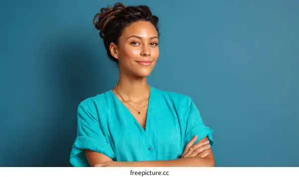 Confident Woman in Teal Outfit Against a Blue Background