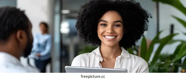 Smiling Businesswoman Holding Tablet in Modern Office