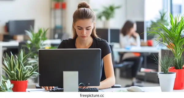 Young Woman Working on a Computer in a Modern Office