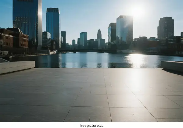 Sunlit urban waterfront with modern skyscrapers in the background