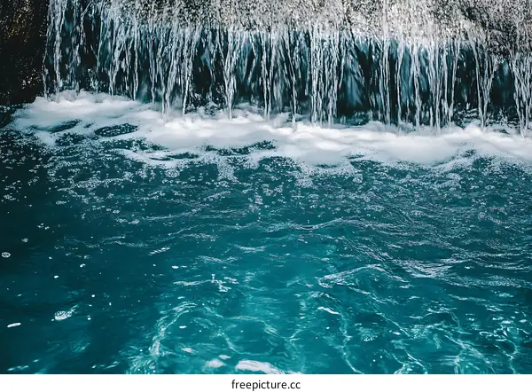 Water Flowing Over Rocks in a Pool