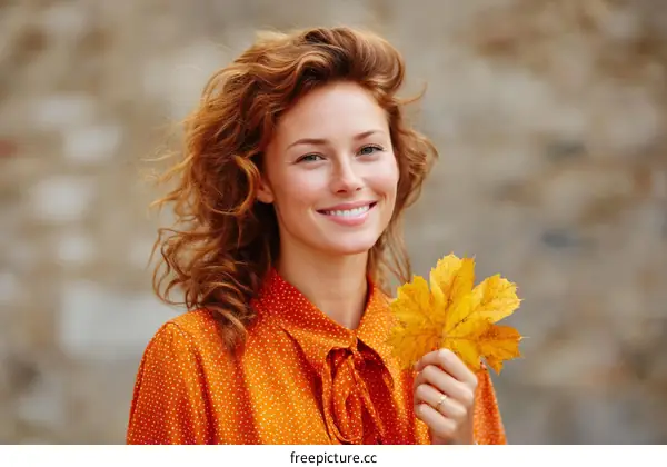 Smiling Woman with Autumn Leaf Outdoors