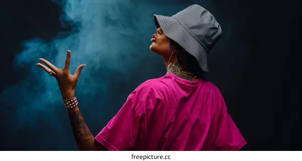 African American woman blowing smoke from her mouth