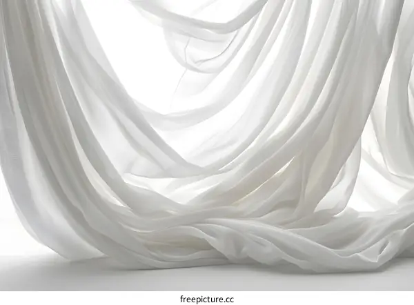Flowing white curtains against a white background