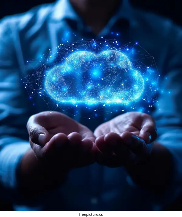 Businessman holding a glowing blue cloud of data in his hands