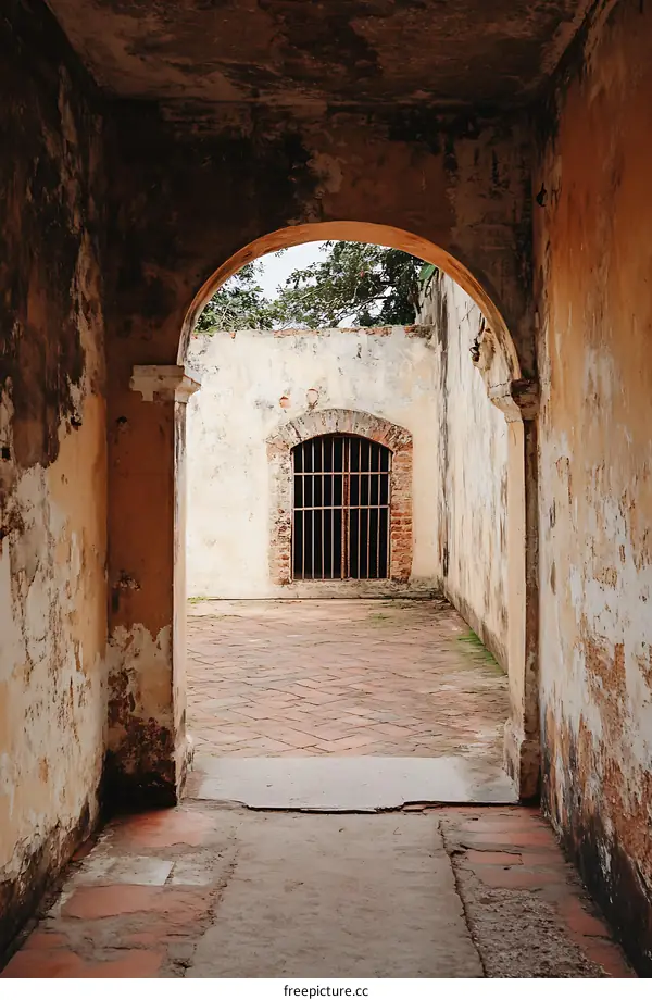 Old Brick Pathway Through Archway In Historic Building
