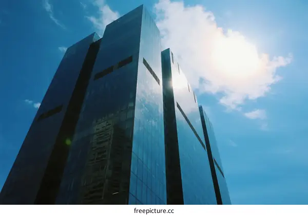 Tall modern glass building under a clear blue sky