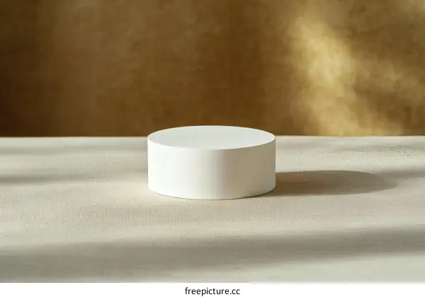 Empty White Cylindrical Display Platform on Beige Fabric