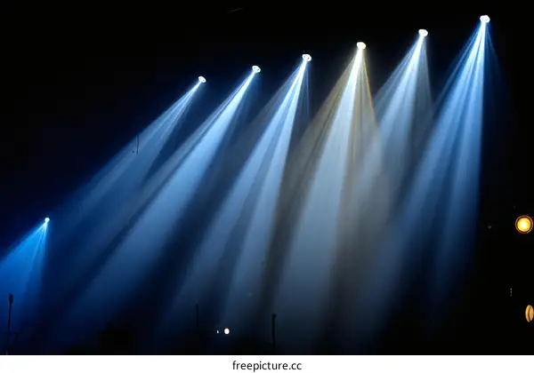 Stage Lighting Beams Illuminating a Dark Area