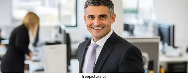 Smiling Businessman in Office Setting